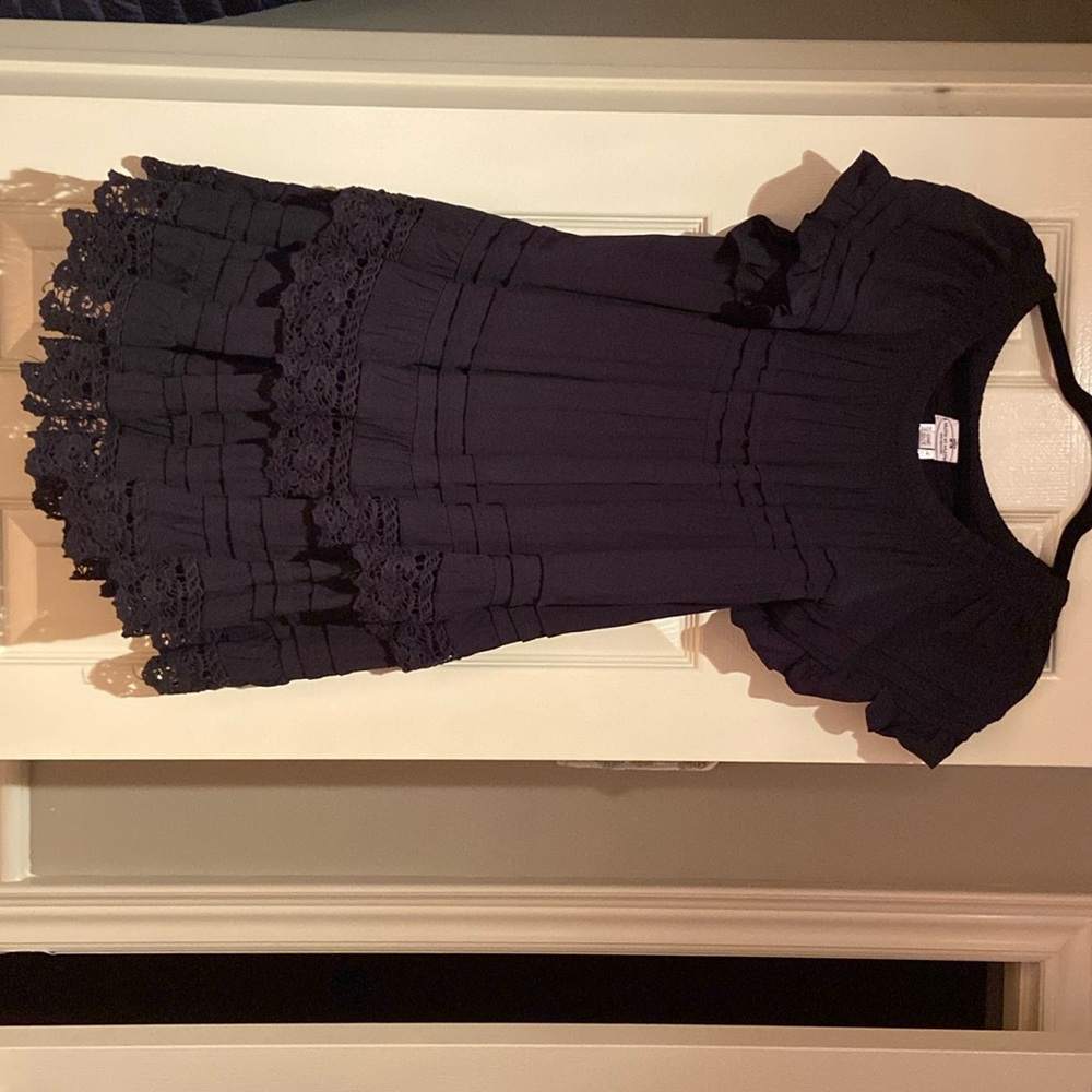 Women’s black dress with ruffles. Brand new. Size small/medium